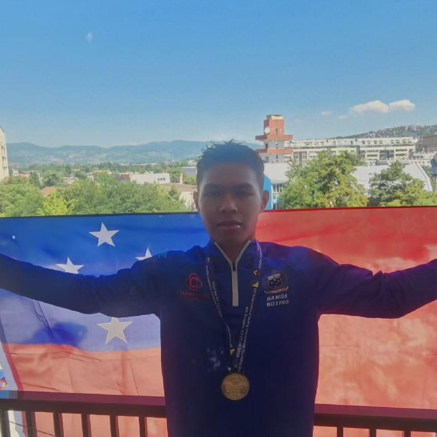 SUBA boxer holding the Samoan flag with his medal in Europe