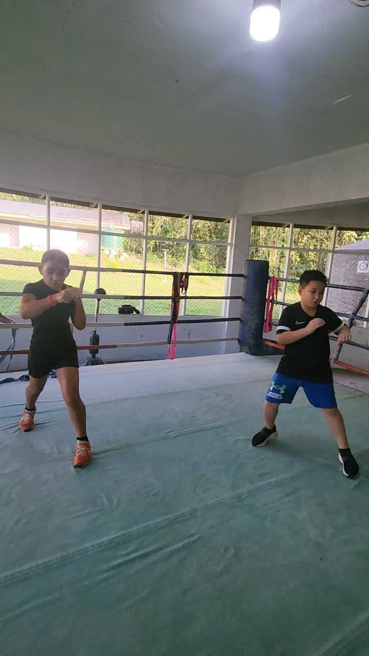 Two young boxers practising stance and footwork in the SUBA ring