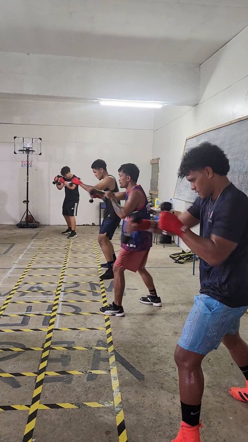 Competition team boxers shadowboxing with hand weights
